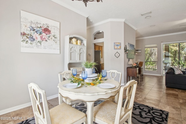dining room featuring ornamental molding, baseboards, and tile patterned flooring