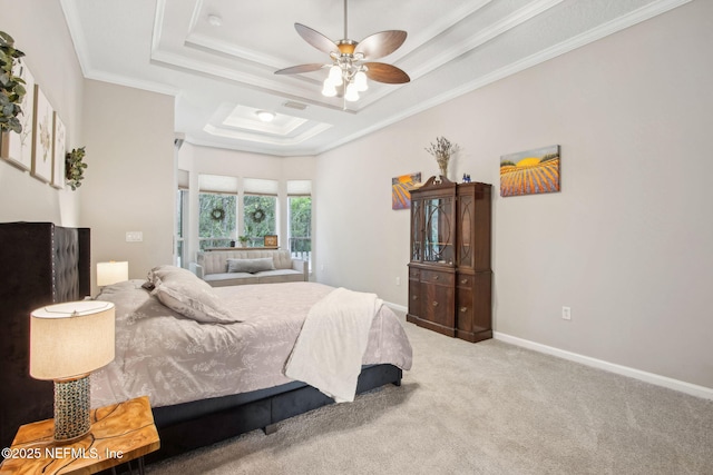 carpeted bedroom featuring a raised ceiling, ornamental molding, baseboards, and a ceiling fan