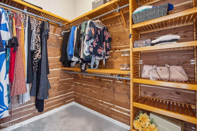 walk in closet featuring carpet flooring