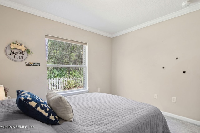bedroom with carpet flooring, ornamental molding, and baseboards