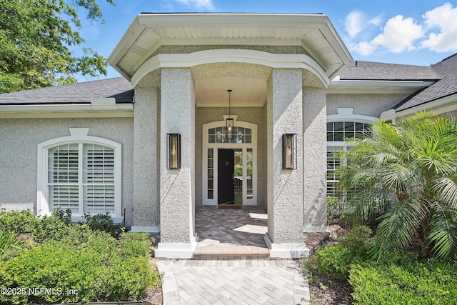 13815 Admirals Bend Dr, Jacksonville, FL 32225 - property entrance with a shingled roof and stucco siding