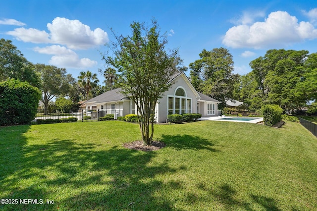 13815 Admirals Bend Dr, Jacksonville, FL 32225 - rear view of property featuring a yard, a fenced in pool, fence, and stucco siding