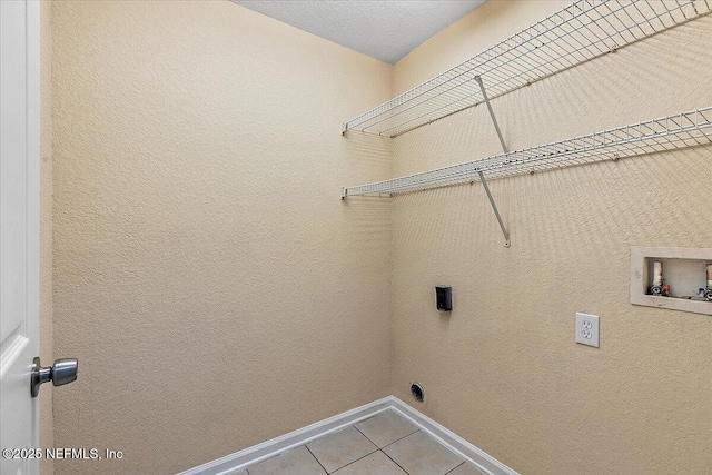 8550 Argyle Business Loop Unit 407, Jacksonville, FL 32244 - laundry area with light tile patterned floors, hookup for a washing machine, and baseboards