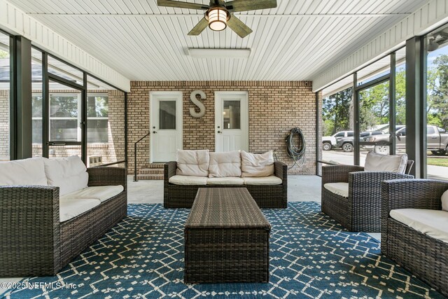 sunroom with an outdoor living space and ceiling fan