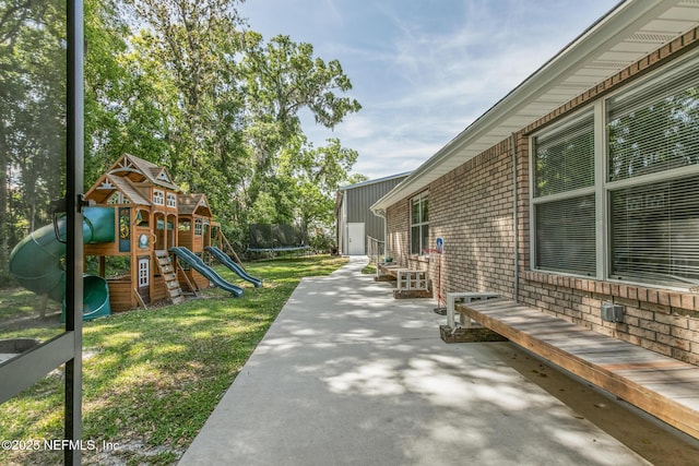 view of patio / terrace featuring a playground and a trampoline