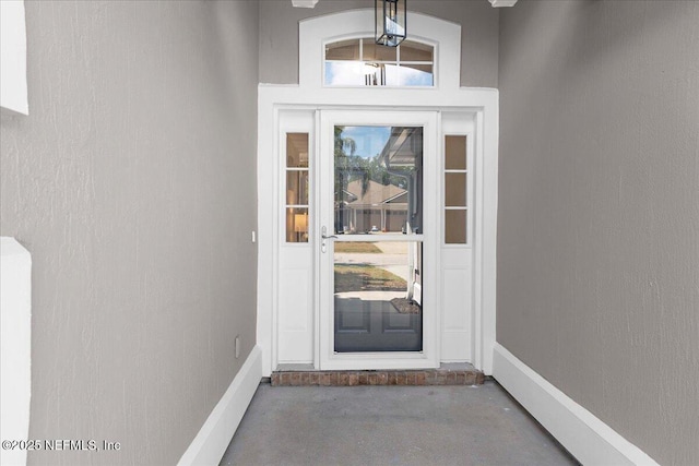view of exterior entry with stucco siding