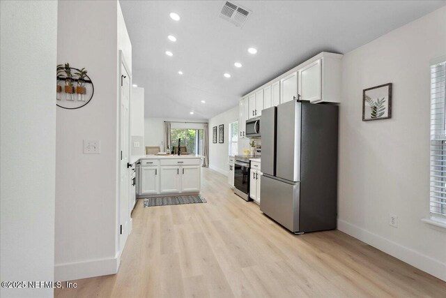 kitchen featuring light wood-style floors, appliances with stainless steel finishes, baseboards, and recessed lighting