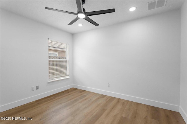 empty room featuring recessed lighting, baseboards, a ceiling fan, and light wood-style floors