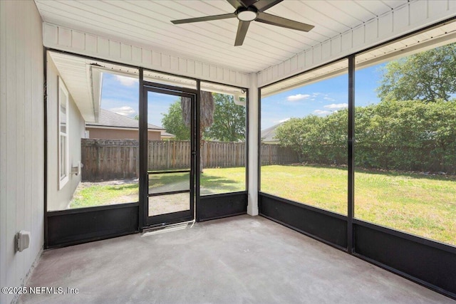 unfurnished sunroom with a ceiling fan