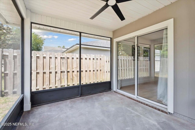 unfurnished sunroom with ceiling fan and a wealth of natural light