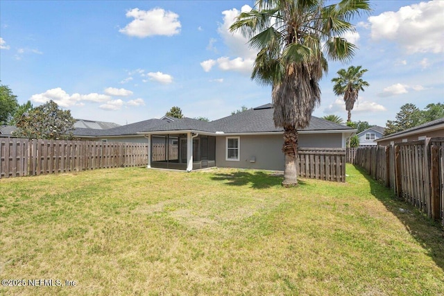 view of yard with a sunroom and a fenced backyard