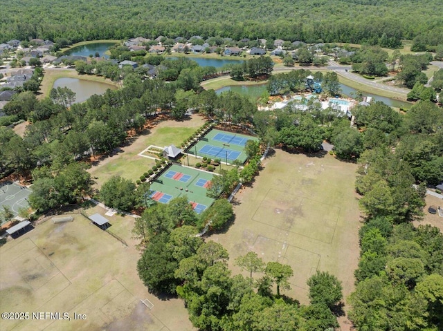 aerial view with a water view and a wooded view