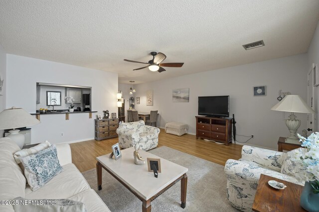 1830 Sevilla Blvd Unit 208, Atlantic Beach, FL 32233 - living room with ceiling fan, wood finished floors, and a textured ceiling