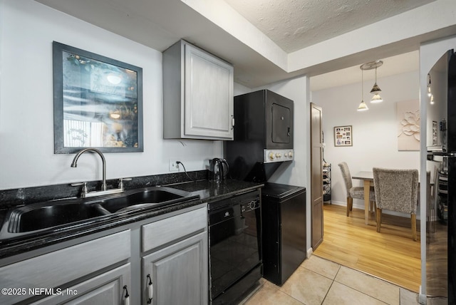 1830 Sevilla Blvd Unit 208, Atlantic Beach, FL 32233 - kitchen featuring black dishwasher, a sink, light tile patterned floors, dark stone countertops, and gray cabinetry