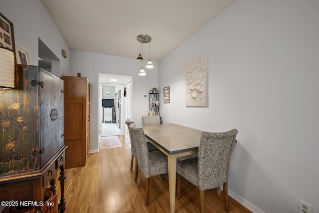 1830 Sevilla Blvd Unit 208, Atlantic Beach, FL 32233 - dining room featuring light wood finished floors, baseboards, and a textured ceiling