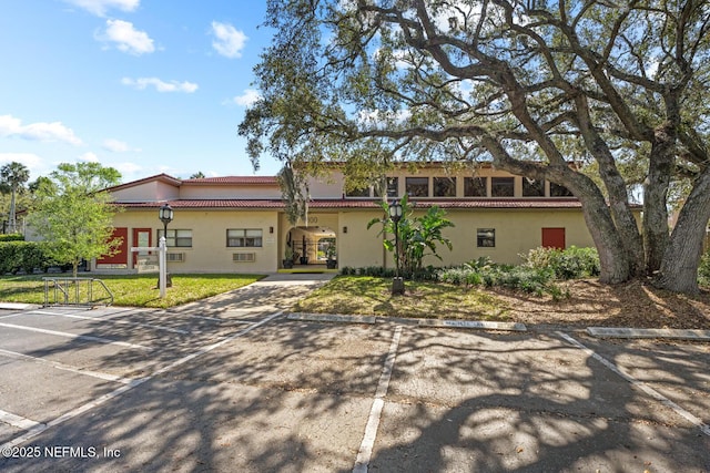 1830 Sevilla Blvd Unit 208, Atlantic Beach, FL 32233 - mediterranean / spanish-style house with stucco siding, a front yard, and uncovered parking