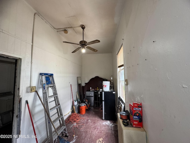 misc room featuring ceiling fan and concrete flooring