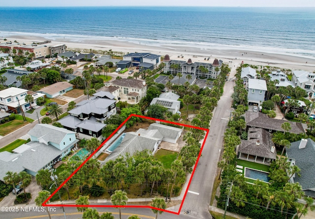 aerial view of residential area with expansive coastline and property boundaries highlighted