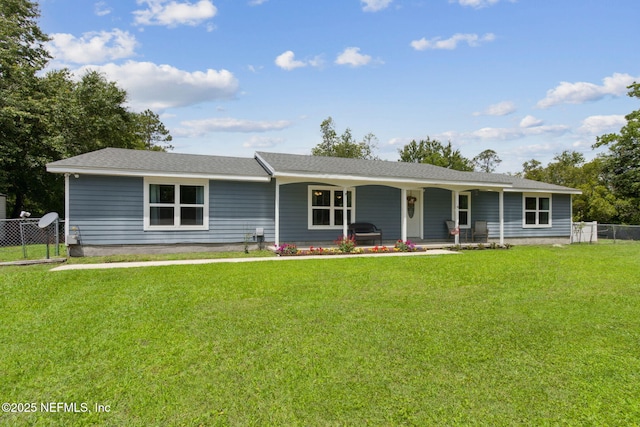 ranch-style home with fence, covered porch, and a front yard