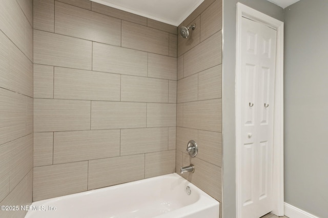bathroom featuring  shower combination and baseboards