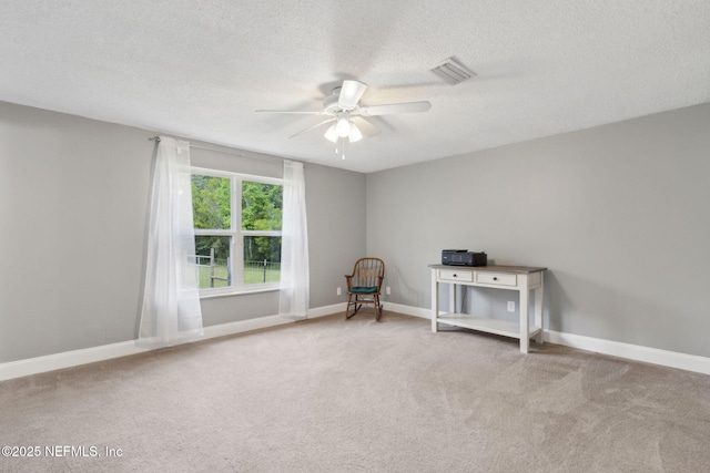 unfurnished room with visible vents, baseboards, a textured ceiling, a ceiling fan, and carpet