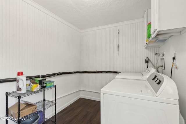 laundry room with a textured ceiling, dark wood finished floors, cabinet space, baseboards, and washer and clothes dryer