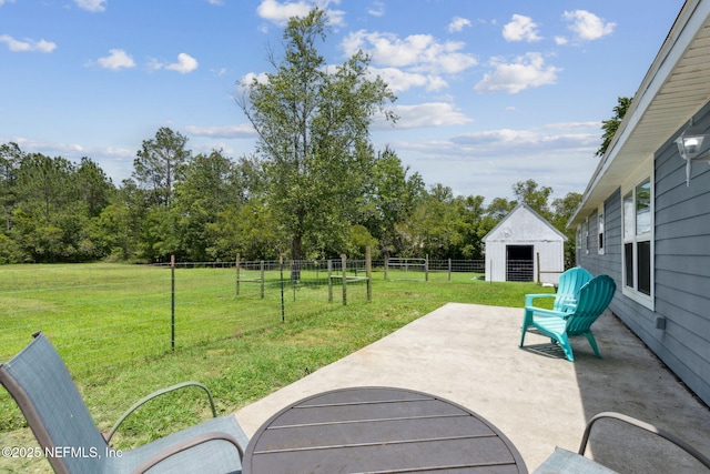 view of patio featuring fence and an outdoor structure