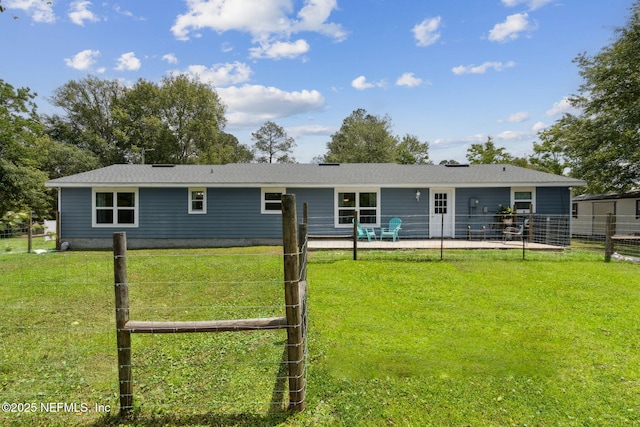 back of property featuring a patio, a lawn, and fence