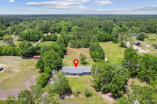 drone / aerial view with a view of trees