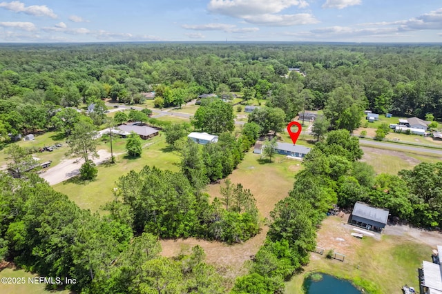 aerial view featuring a view of trees