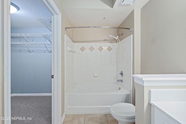 full bath with tile patterned flooring, shower / tub combination, vanity, toilet, and a spacious closet