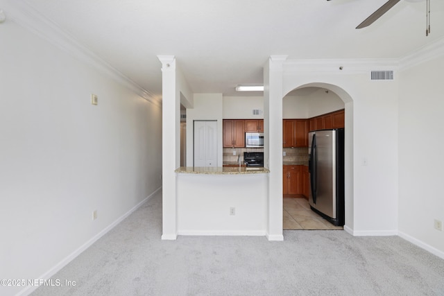 kitchen featuring ceiling fan, light colored carpet, visible vents, tasteful backsplash, and stainless steel appliances