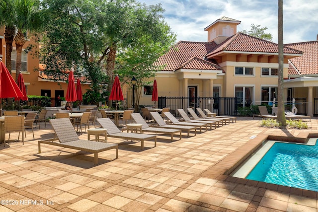 view of pool with a fenced in pool, fence, and a patio area