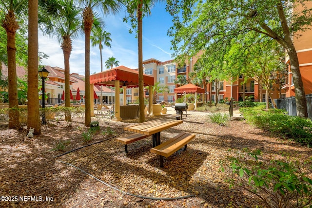 view of community featuring fence, a gazebo, and a residential view