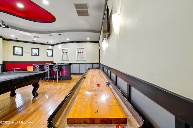 playroom featuring wood-type flooring, wainscoting, recessed lighting, and visible vents