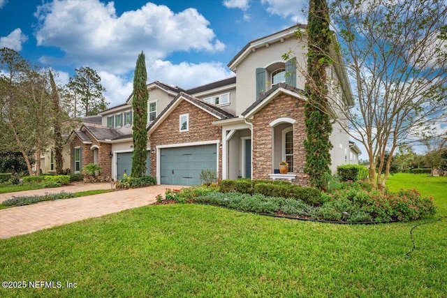 view of front of property featuring stone siding, a garage, stucco siding, a front yard, and driveway