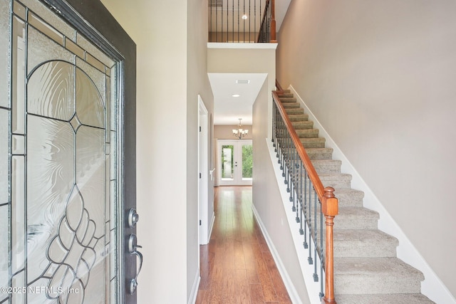 2968 Ravine Hill Dr, Middleburg, FL 32068 - entrance foyer with stairway, wood finished floors, a high ceiling, baseboards, and a chandelier