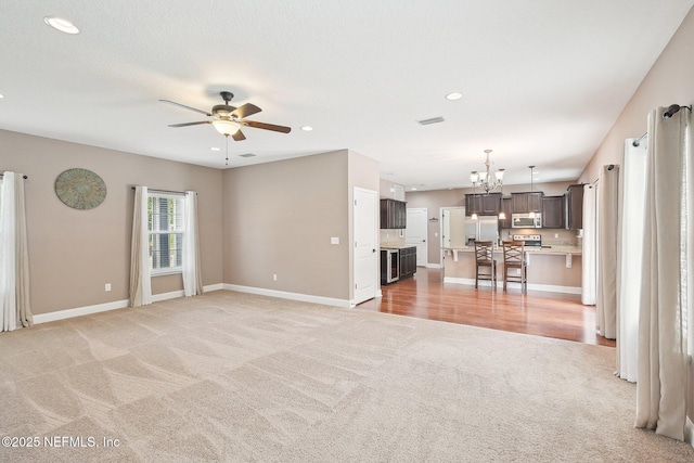 2968 Ravine Hill Dr, Middleburg, FL 32068 - unfurnished living room with light carpet, a ceiling fan, baseboards, recessed lighting, and a chandelier