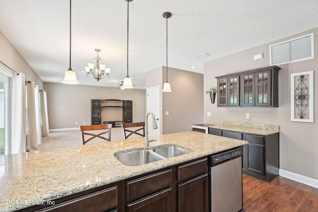 2968 Ravine Hill Dr, Middleburg, FL 32068 - kitchen with dishwasher, a sink, dark brown cabinets, and baseboards
