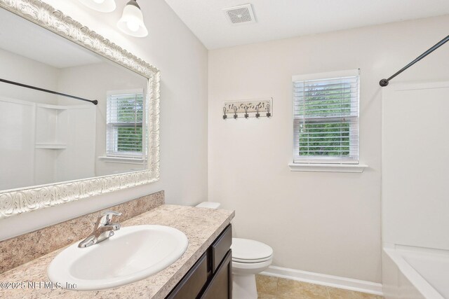 2968 Ravine Hill Dr, Middleburg, FL 32068 - bathroom with vanity, toilet, washtub / shower combination, tile patterned flooring, and baseboards