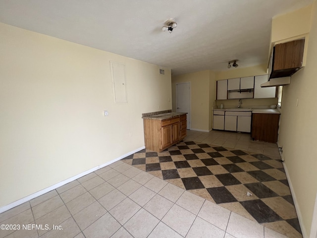 2673 Trollie Ln Unit 1, Jacksonville, FL 32211 - kitchen featuring a sink, baseboards, dark tile patterned flooring, and visible vents
