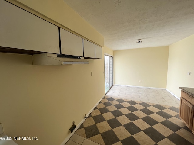 2673 Trollie Ln Unit 1, Jacksonville, FL 32211 - spare room with a textured ceiling, baseboards, and light tile patterned floors