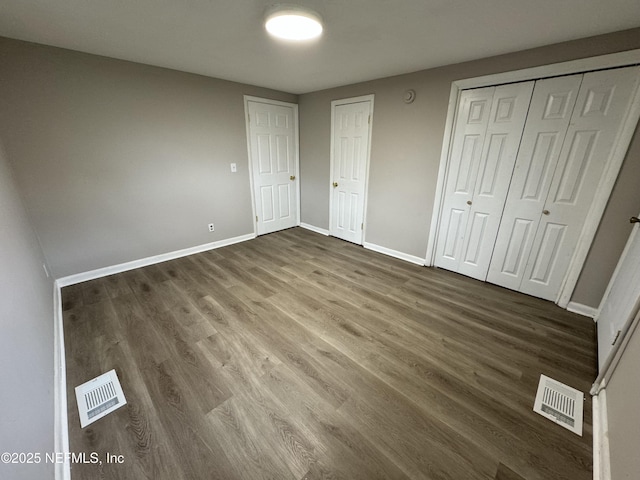 5612 Oliver St, Jacksonville, FL 32211 - unfurnished bedroom with baseboards, wood finished floors, and visible vents