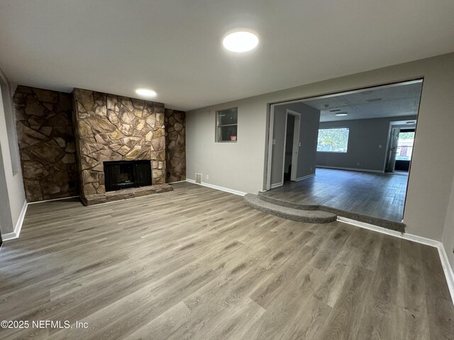 5612 Oliver St, Jacksonville, FL 32211 - unfurnished living room featuring baseboards, wood finished floors, and a fireplace