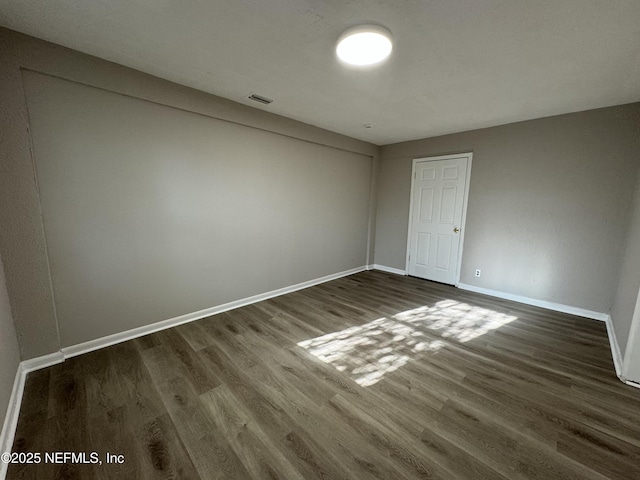 5612 Oliver St, Jacksonville, FL 32211 - empty room with baseboards, dark wood finished floors, and visible vents