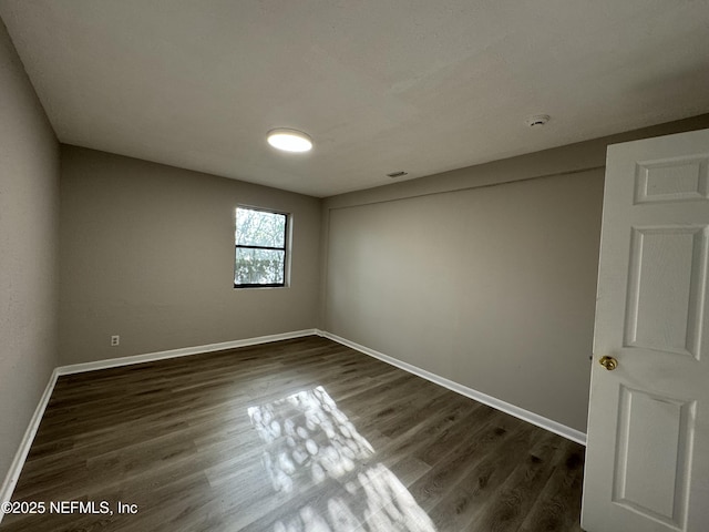 5612 Oliver St, Jacksonville, FL 32211 - unfurnished room featuring baseboards and dark wood-type flooring