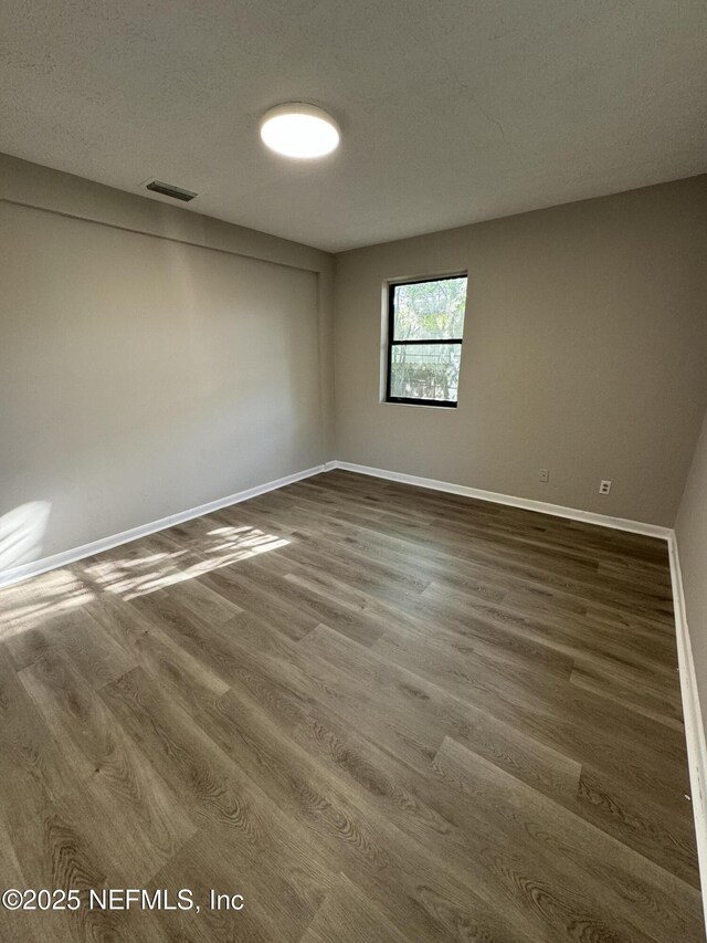5612 Oliver St, Jacksonville, FL 32211 - unfurnished room with baseboards, visible vents, and wood finished floors
