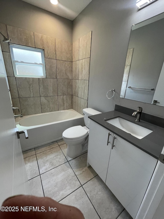 bathroom featuring vanity, bathing tub / shower combination, and toilet