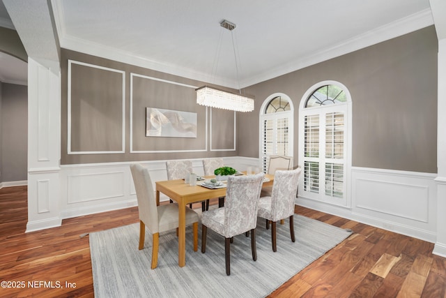 725 Carthage Pl, Saint Johns, FL 32259 - dining space featuring a decorative wall, wood finished floors, ornamental molding, arched walkways, and a wainscoted wall