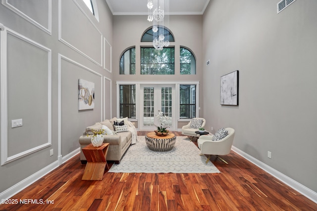 725 Carthage Pl, Saint Johns, FL 32259 - living area featuring wood finished floors, a chandelier, baseboards, crown molding, and a high ceiling